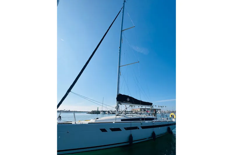 Slide: The Image of 2024 Jeanneau Sun Odyssey 349 sailboat docked under clear blue sky. - 4