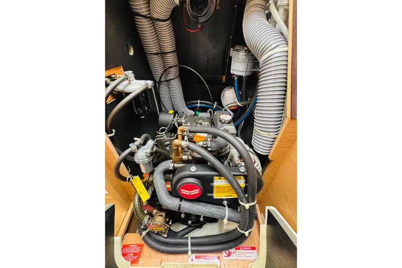 Slide: The Image of Engine compartment of 2024 Jeanneau Sun Odyssey 349 sailboat, showcasing detailed mechanical components. - 67