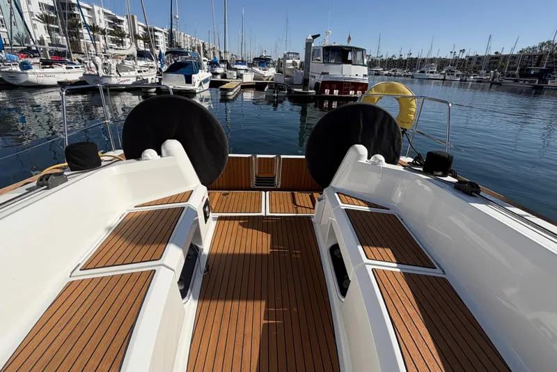 Slide: The Image of 2024 Jeanneau Sun Odyssey 349 sailboat with teak deck in marina setting. - 24