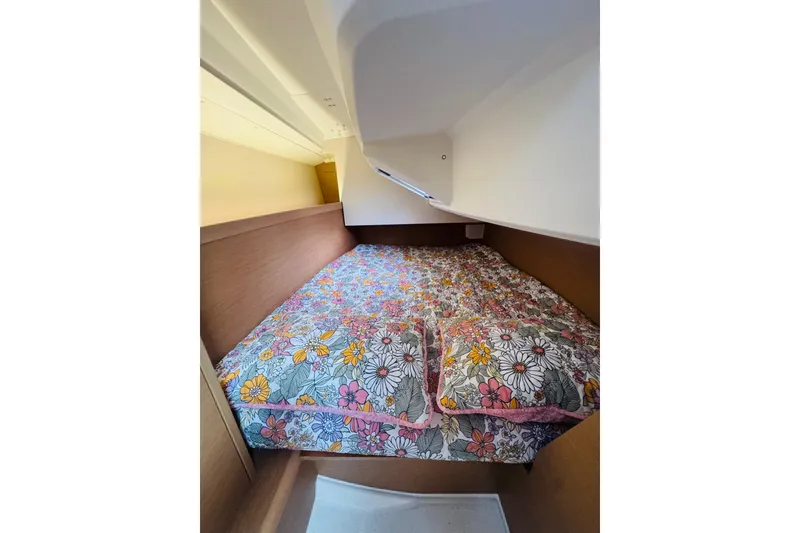 Slide: The Image of Cozy cabin interior of 2024 Jeanneau Sun Odyssey 349 with floral bedding. - 57