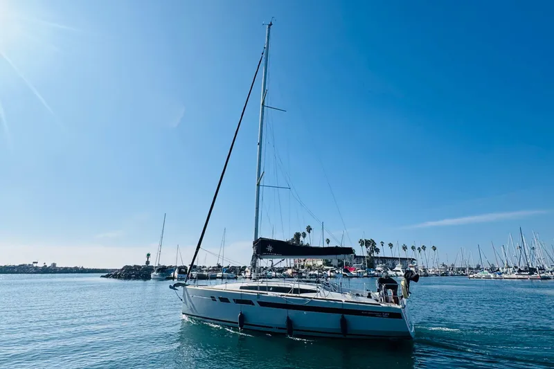Slide: The Image of 2024 Jeanneau Sun Odyssey 349 sailboat in a sunny marina setting. - 2