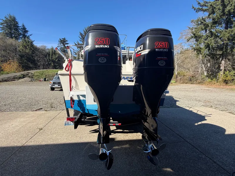 Slide: The Image of A 1974 Fiberform Sportfisher 31 with two Suzuki 250 outboard engines on a trailer. - 6