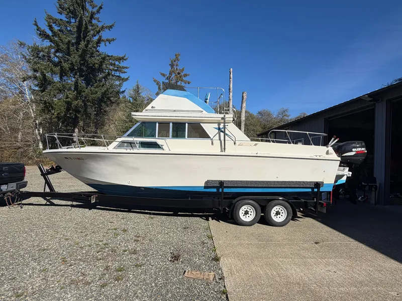 Slide: The Image of A 1974 Fiberform Sportfisher 31 on a trailer beside a building. - 1