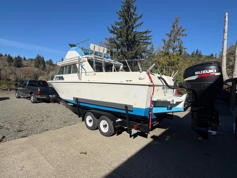 Slide: The Image of A 1974 Fiberform Sportfisher 31 on a trailer, with Suzuki outboard motor, in a rural setting. - 5