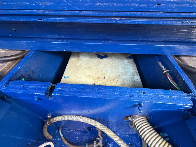 Slide: The Image of A blue-painted boat section with hoses and wires visible. - 25