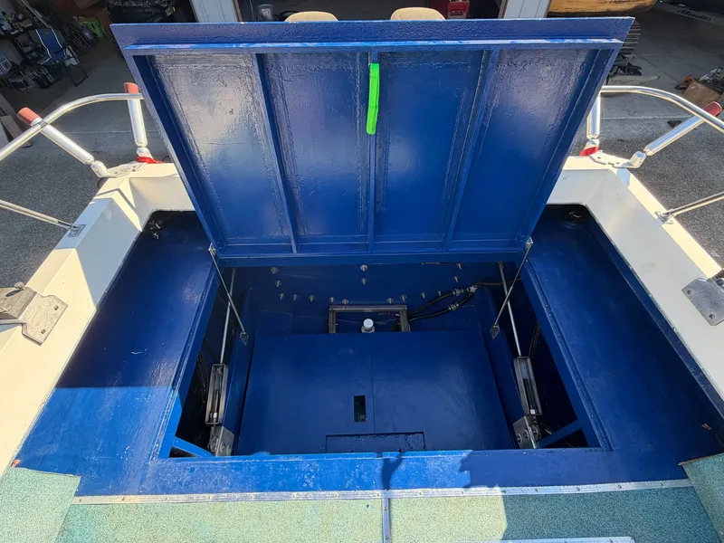 Slide: The Image of View of the open engine compartment of a 1974 Fiberform Sportfisher 31 with blue paint. - 15