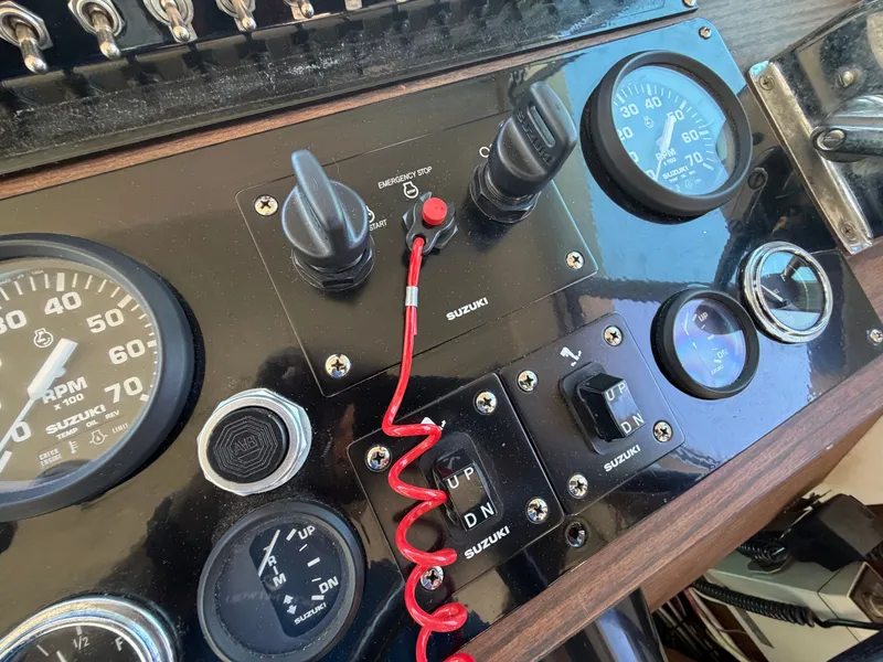 Slide: The Image of Close-up of a boat's dashboard with various instruments and switches. - 42
