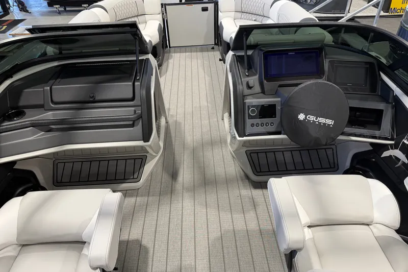Slide: The Image of Interior view of 2027 Avalon 2585 EXCALIBUR QLWS boat with modern seating and dashboard. - 11