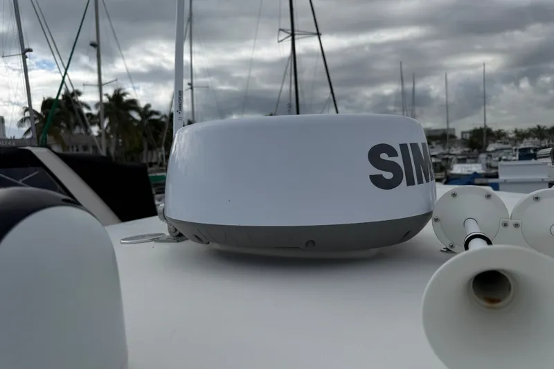 Slide: The Image of Radar equipment on 2022 NauticStar 28 XS boat, docked with cloudy sky background. - 29