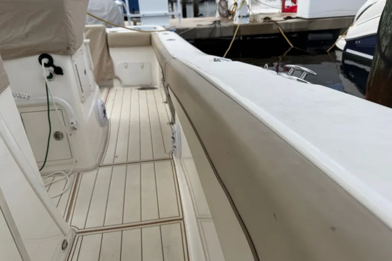 Slide: The Image of 2022 NauticStar 28 XS boat interior with clean deck and docked at marina. - 20