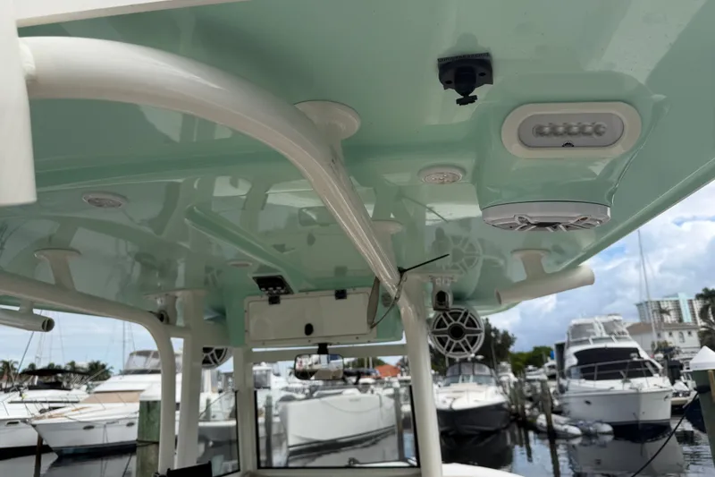 Slide: The Image of 2022 NauticStar 28 XS boat interior with speakers and lighting at marina. - 11