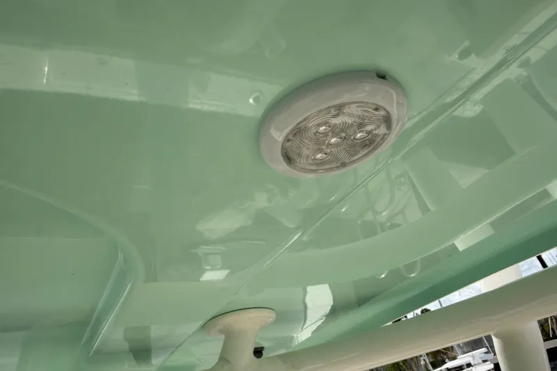 Slide: The Image of LED light fixture on 2022 NauticStar 28 XS boat's mint green ceiling. - 57