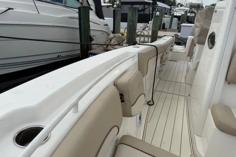 Slide: The Image of 2022 NauticStar 28 XS boat interior with beige seating and sleek design. - 25