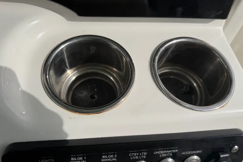 Slide: The Image of Cup holders and control panel on 2022 NauticStar 28 XS boat. - 55
