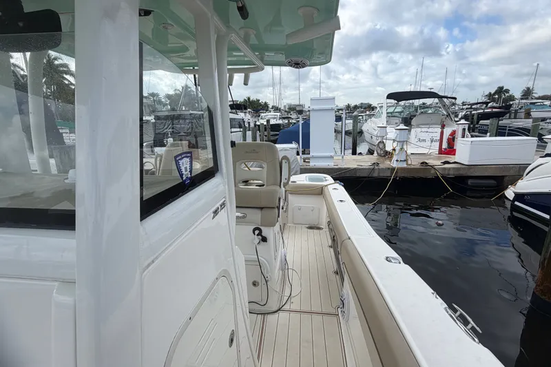 Slide: The Image of 2022 NauticStar 28 XS boat docked at marina with other vessels. - 54
