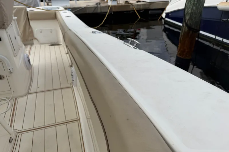Slide: The Image of 2022 NauticStar 28 XS boat interior with clean deck and dock view. - 17