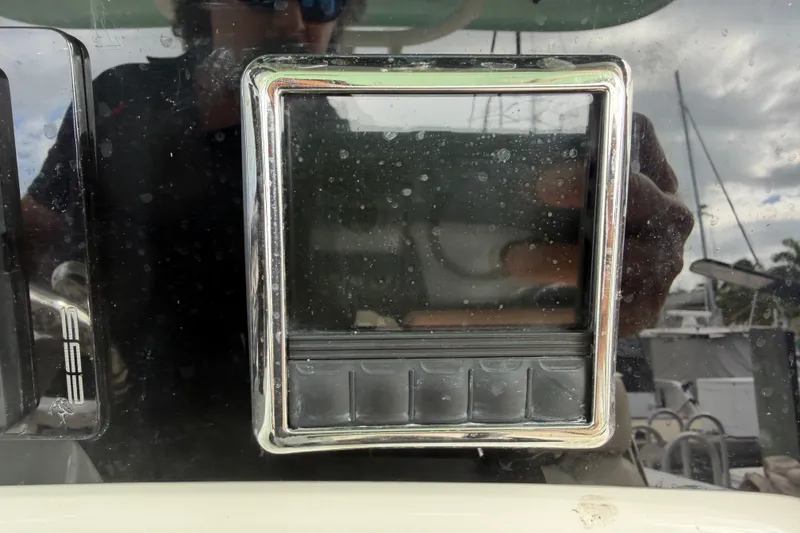Slide: The Image of Control panel on a 2022 NauticStar 28 XS boat, featuring a chrome frame. - 43