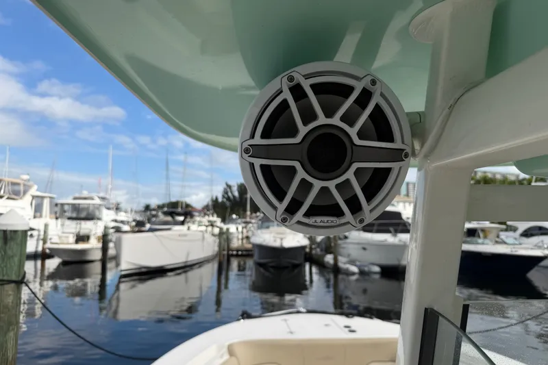 Slide: The Image of 2022 NauticStar 28 XS boat with JL Audio speaker, docked at marina. - 39