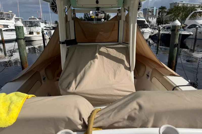 Slide: The Image of 2022 NauticStar 28 XS boat covered at marina, surrounded by other boats. - 5
