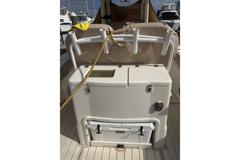 Slide: The Image of 2022 NauticStar 28 XS boat interior with rod holders and storage compartment. - 4