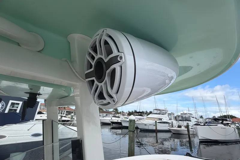 Slide: The Image of Speaker mounted on a 2022 NauticStar 28 XS boat, docked at a marina. - 52