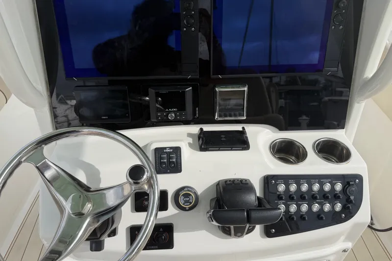 Slide: The Image of 2022 NauticStar 28 XS boat dashboard with steering wheel and control panel. - 41