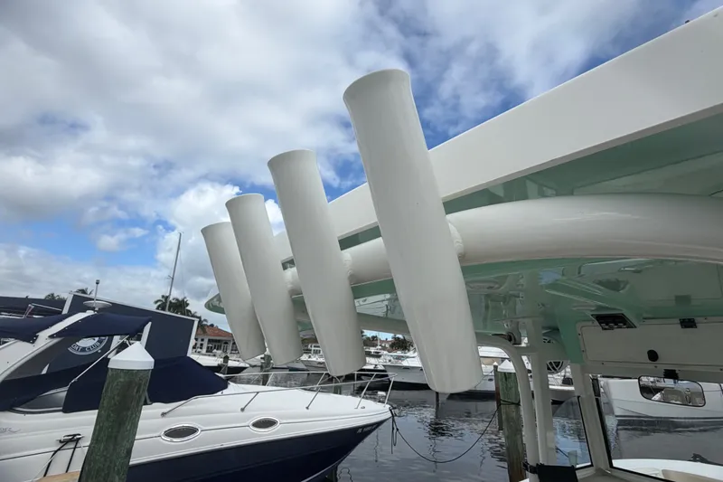 Slide: The Image of 2022 NauticStar 28 XS boat with rod holders, docked under cloudy sky. - 46