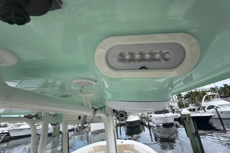 Slide: The Image of 2022 NauticStar 28 XS boat interior with LED lighting and marina view. - 47