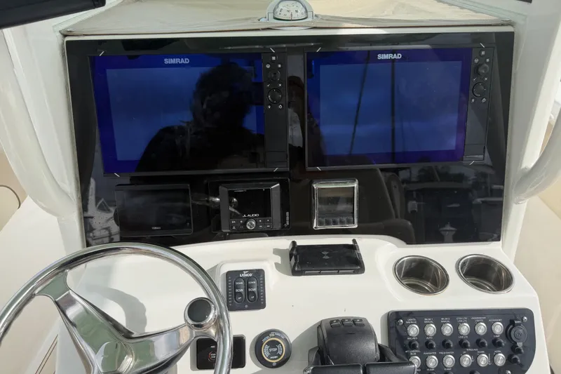 Slide: The Image of Control panel of 2022 NauticStar 28 XS boat with dual Simrad displays. - 40