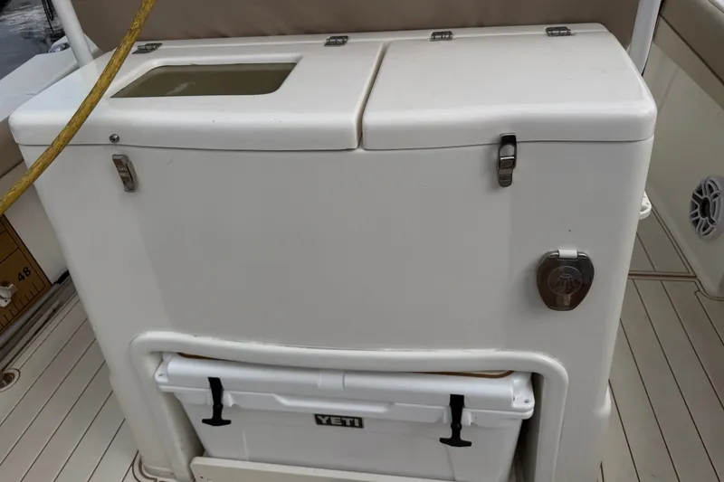 Slide: The Image of 2022 NauticStar 28 XS boat with Yeti cooler and storage compartment. - 10