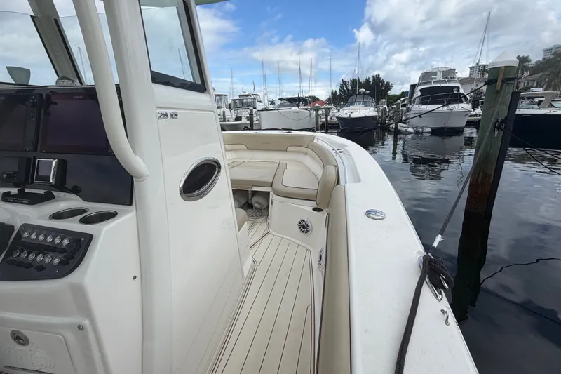 Slide: The Image of 2022 NauticStar 28 XS boat docked at marina with clear sky. - 50