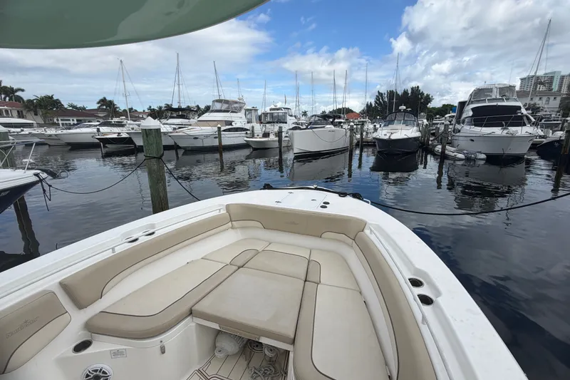 Slide: The Image of 2022 NauticStar 28 XS boat docked in a marina with other vessels. - 51