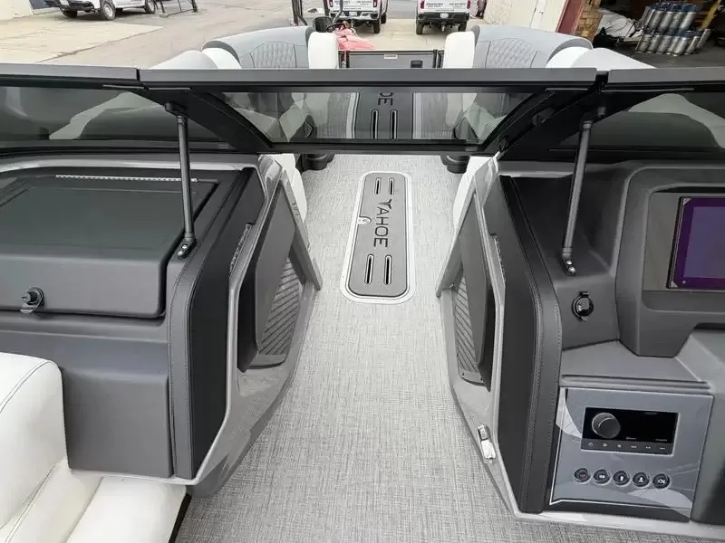 Slide: The Image of Interior view of a modern boat with gray carpeting and black dashboard features. - 13