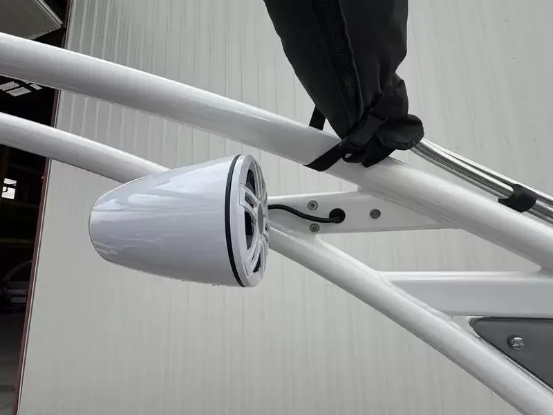 Slide: The Image of Close-up of a white speaker on a boat with a metal frame. - 12