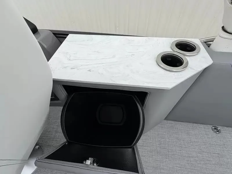 Slide: The Image of A modern boat with sleek gray interior and a white table featuring cup holders. - 18