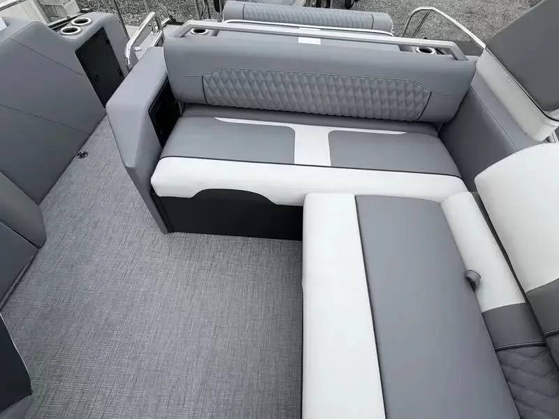 Slide: The Image of The image shows a luxurious gray and white boat lounge with cushioned seating and cup holders. - 21
