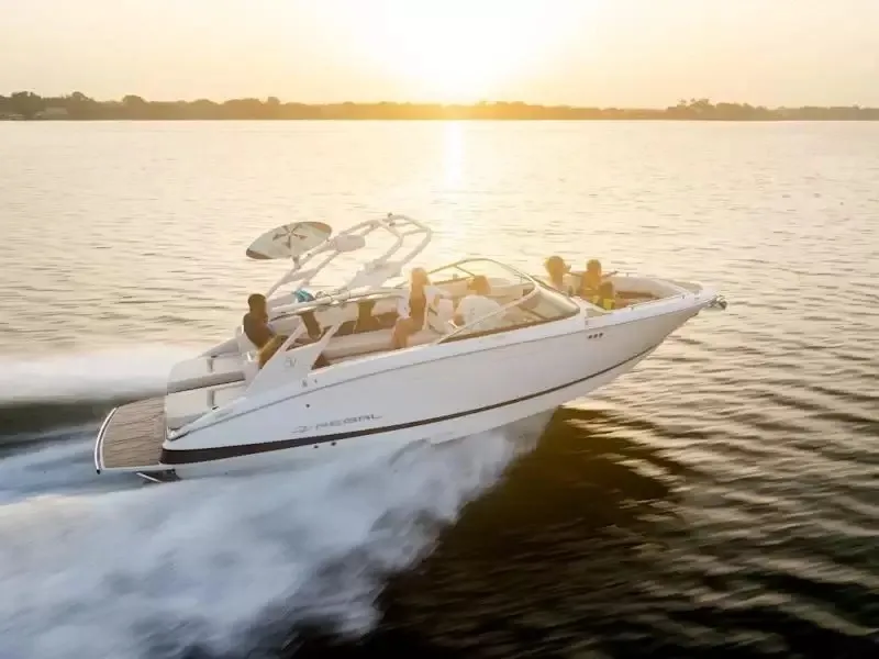 The Image of 2027 Regal LS6 cruising on a calm lake at sunset. - 1