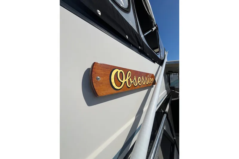 Slide: The Image of 1989 Californian 45 Motor Yacht with "Obsession" nameplate, docked under clear blue sky. - 4