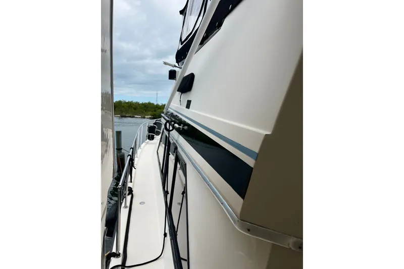 Slide: The Image of 1989 Californian 45 Motor Yacht side view with railing and water backdrop. - 3