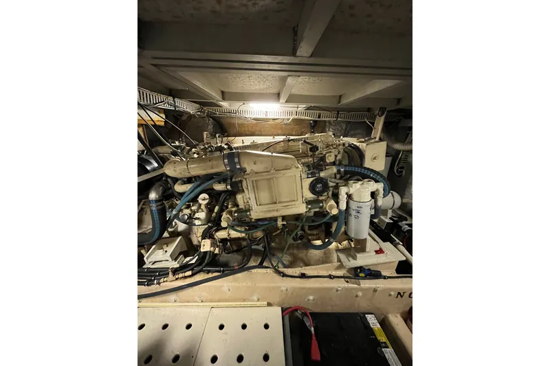 Slide: The Image of Engine room of a 1989 Californian 45 Motor Yacht, showcasing detailed machinery and components. - 47