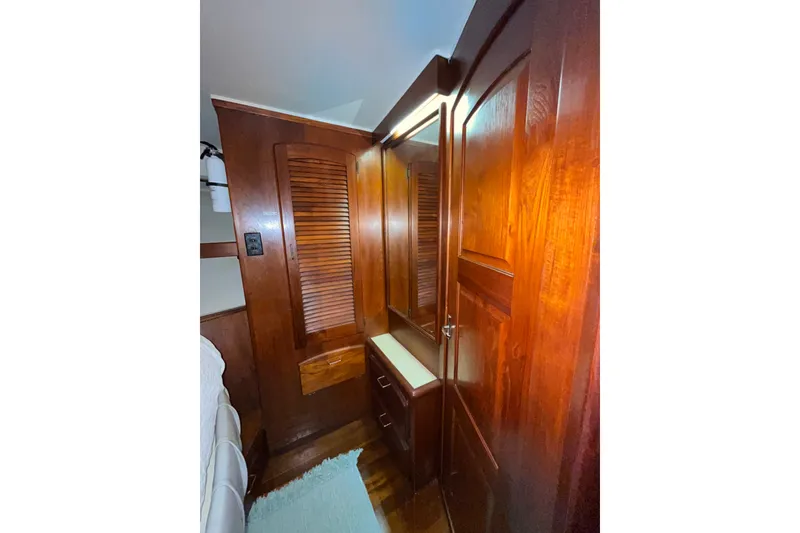 Slide: The Image of Interior of 1989 Californian 45 Motor Yacht with wooden cabinetry and mirror. - 28