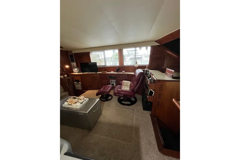 Slide: The Image of Interior of 1989 Californian 45 Motor Yacht with leather seating and wooden cabinetry. - 17