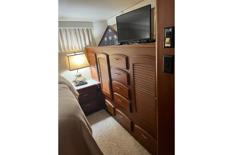 Slide: The Image of Interior of 1989 Californian 45 Motor Yacht with wooden cabinetry and TV. - 34