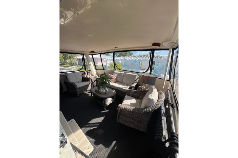 Slide: The Image of Interior of 1989 Californian 45 Motor Yacht with cozy seating and large windows. - 12