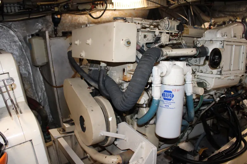 Slide: The Image of Engine room of a 1989 Californian 45 Motor Yacht with visible components and NAPA filter. - 43