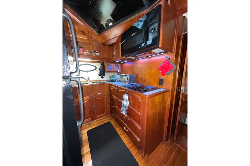 Slide: The Image of Galley kitchen in 1989 Californian 45 Motor Yacht with wooden cabinetry and modern appliances. - 22