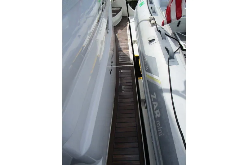 Slide: The Image of Side view of 2006 Neptunus 56 Flybridge yacht with adjacent inflatable boat. - 54