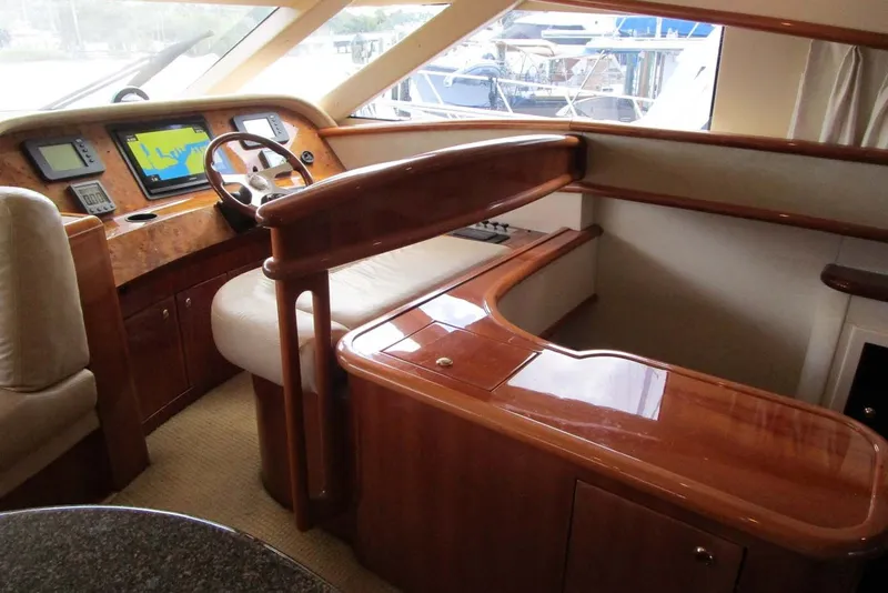 Slide: The Image of Luxurious 2006 Neptunus 56 Flybridge yacht helm with wood finish and navigation displays. - 14