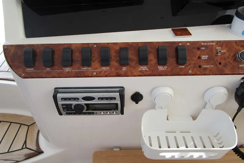 Slide: The Image of Control panel of a 2006 Neptunus 56 Flybridge yacht with switches and stereo system. - 61
