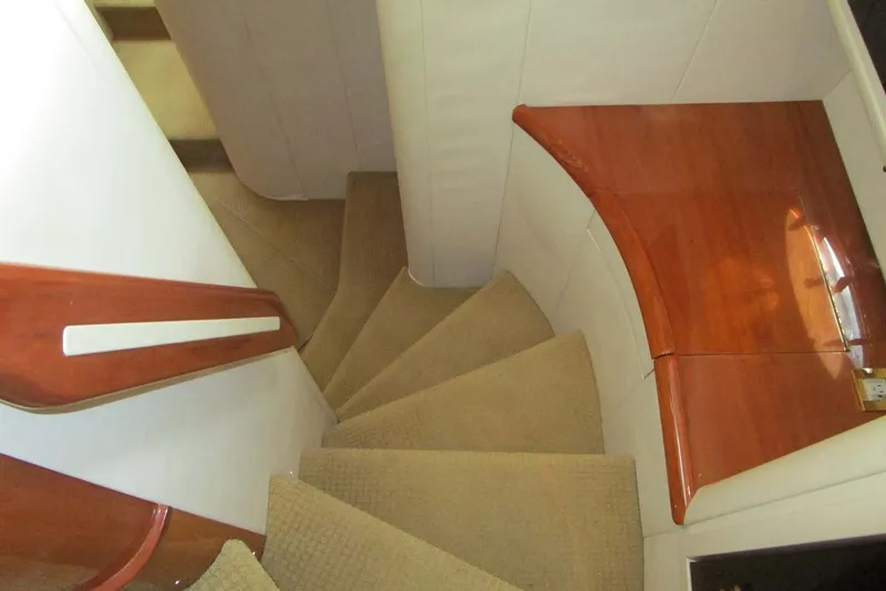 Slide: The Image of Interior staircase of 2006 Neptunus 56 Flybridge yacht with wooden accents and carpeted steps. - 19